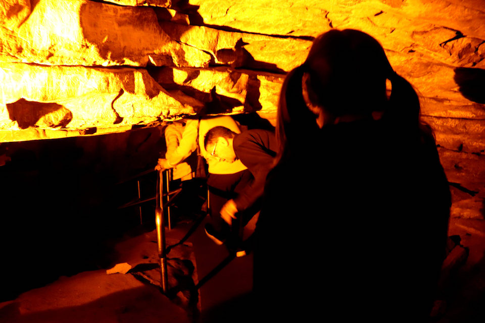 Adults having to duck to get through the caves
