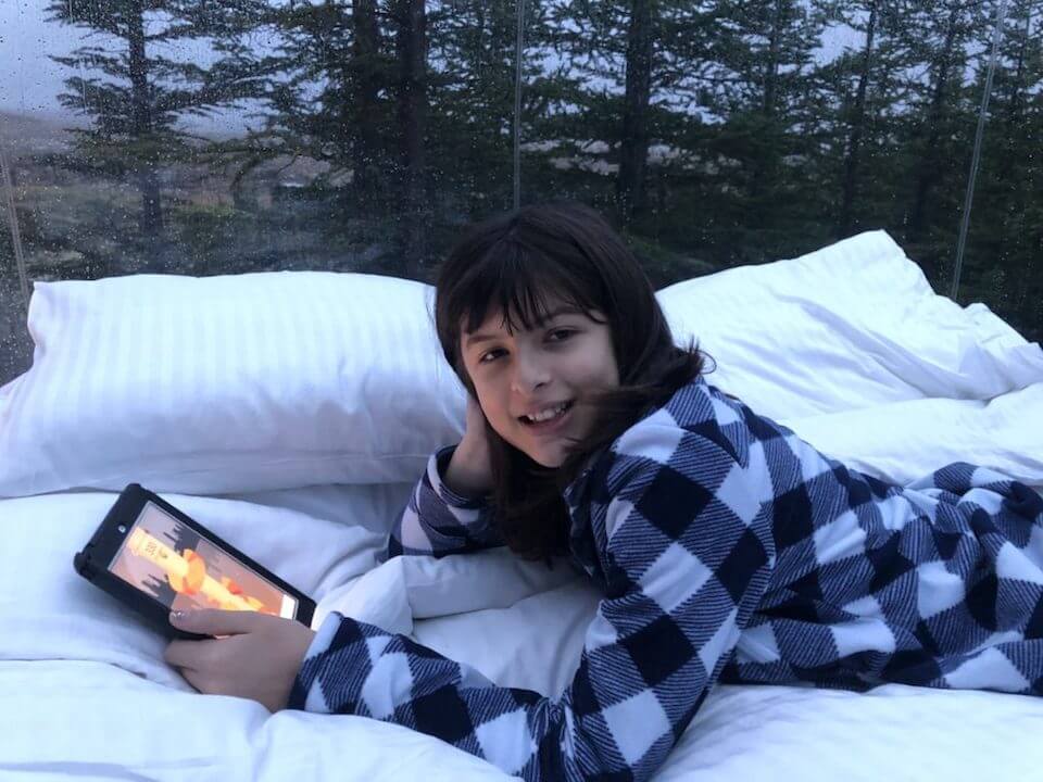 Payton reading on the bed in the bubble