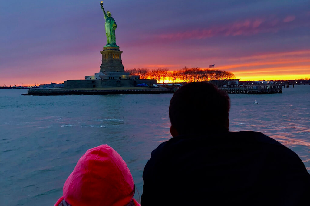 Statue of liberty at sunset from a sightseeing cruise